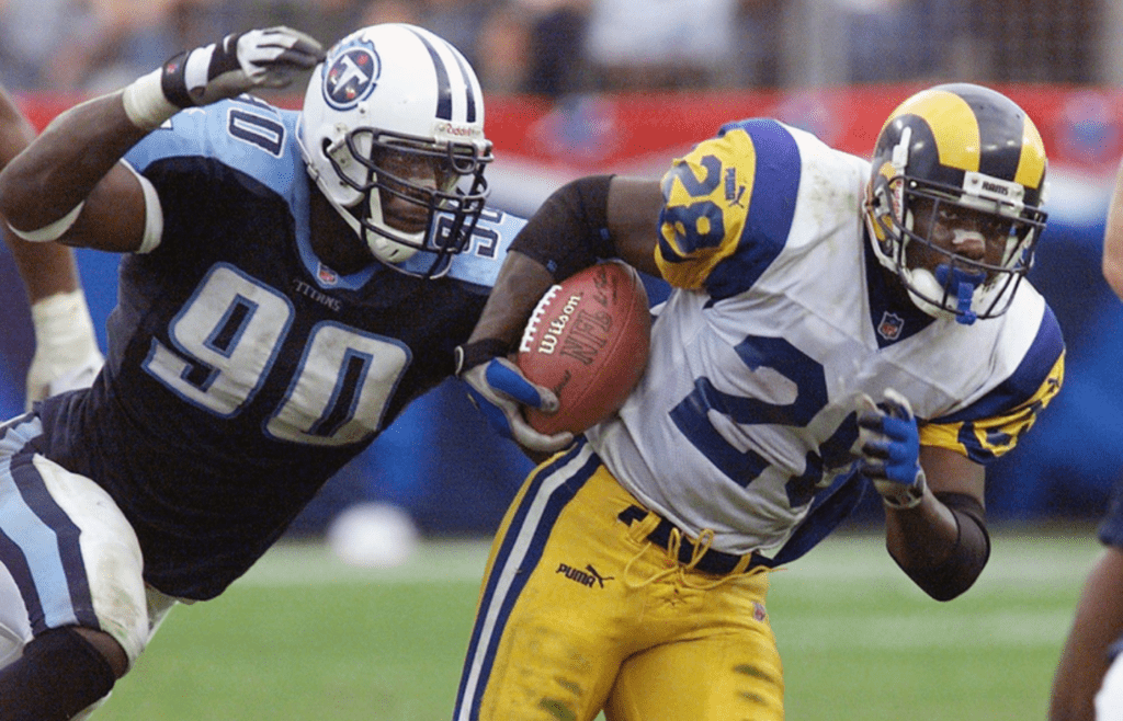 Tennessee Titans rookie and defensive end Jevon Kearse (90) chases down St. Louis Rams back Marshall Faulk (28) during action at Adelpha Coliseum in Nashville on October. 31, 1999.
