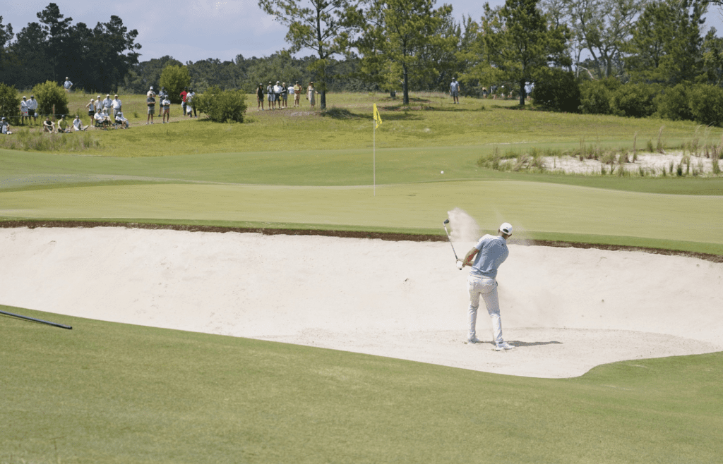 Jun 12, 2021; Ridgeland, South Carolina, USA; Dustin Johnson plays a shot from a bunker onto the fifth green during the third round of the Palmetto Championship at Congaree golf tournament. Mandatory Credit: David Yeazell-Imagn Images