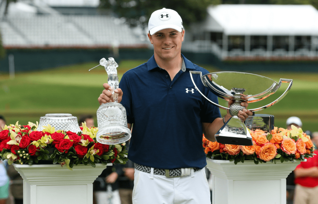 Sep 27, 2015; Atlanta, GA, USA; Jordan Spieth with the tournament trophy and FedEx Cup trophy after winning the final round of the Tour Championship by Coca-Cola at East Lake Golf Club. Mandatory Credit: Jason Getz-Imagn Images