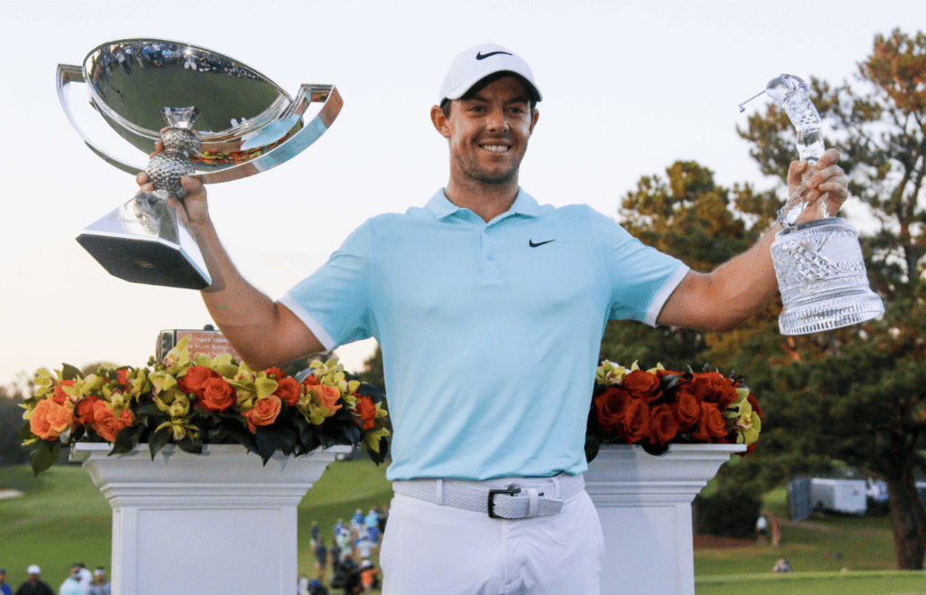 Sep 25, 2016; Atlanta, GA, USA; Rory McIlroy celebrates with the FedEx Cup trophy and the Tour Championship trophy after playing the Tour Championship at East Lake Golf Club. Mandatory Credit: Brett Davis-Imagn Images
