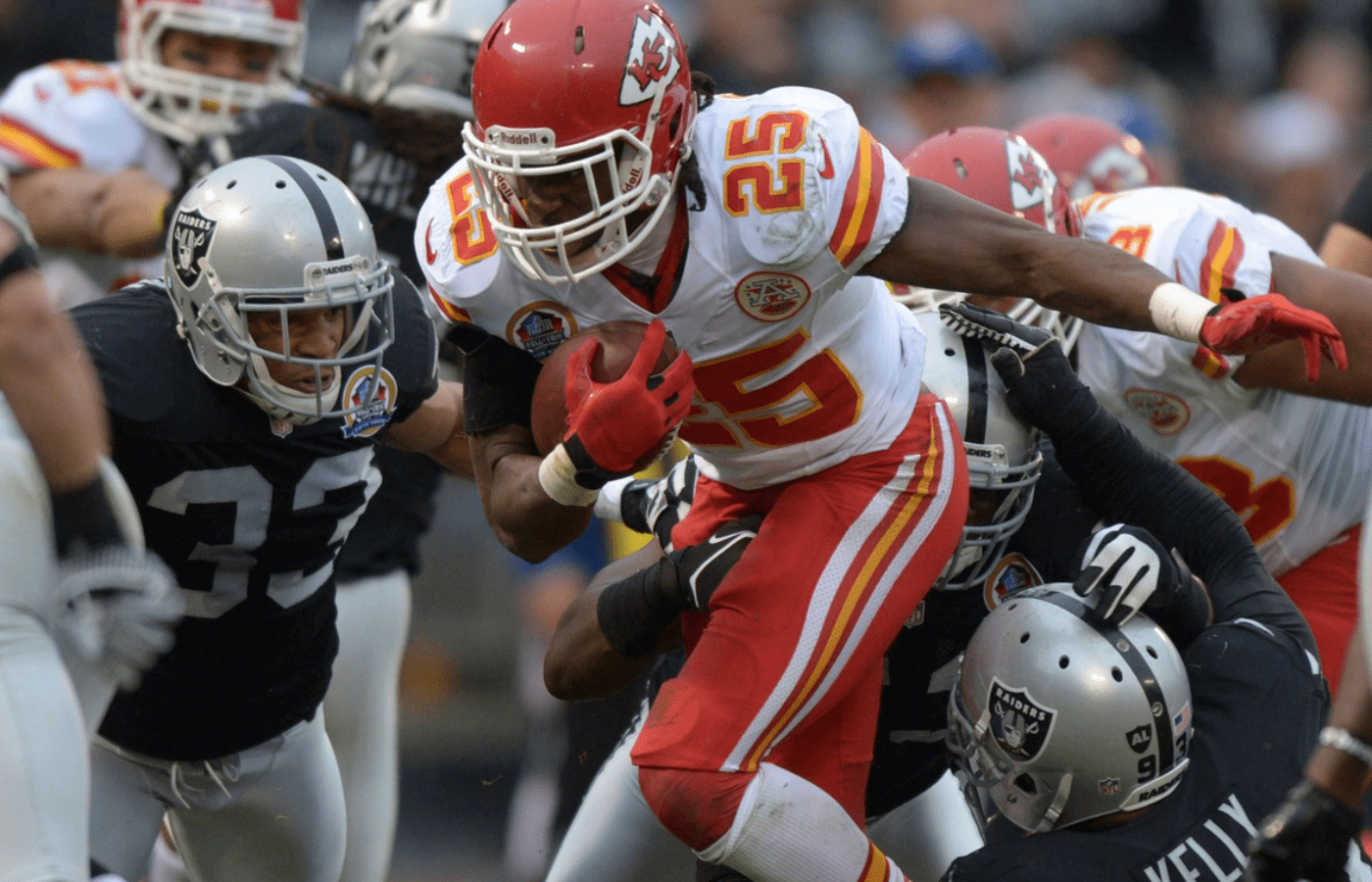 Kansas City Chiefs running back Jamal Charles (25) is tackled by Oakland Raiders safety Tyvon Branch (33), linebacker Omar Gaither (53) and defensive tackle Tommy Kelly (93) at the O.co Coliseum. The Raiders defeated the Chiefs 15-0.