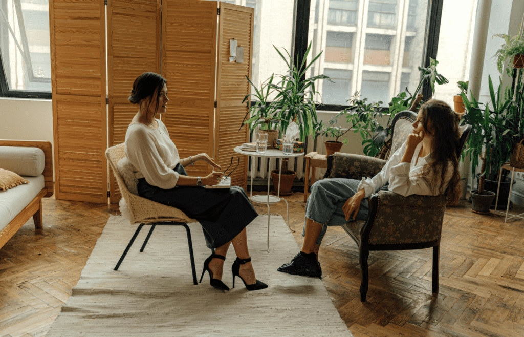 Businesswoman seated, saying “Let’s circle back”