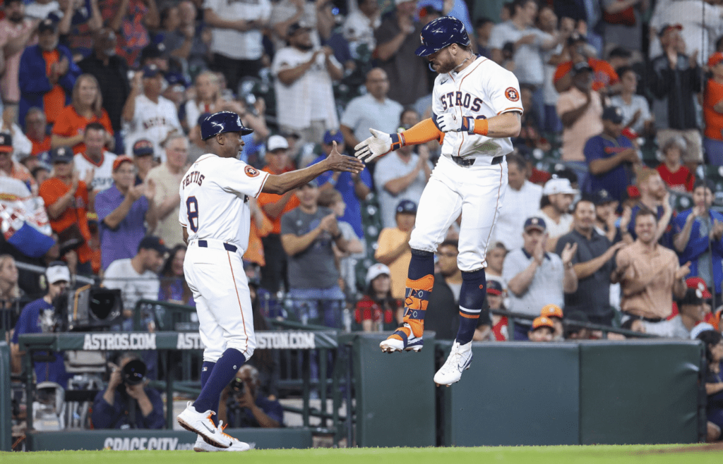 Houston Astros right fielder Trey Cabbage celebrates with third base coach Gary Pettis