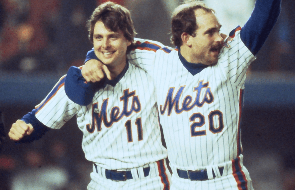 Mets Tim Teufel and Howard Johnson celebrate after defeating the Boston Red Sox in Game 7 to win the World Series at Shea Stadium Oct. 27, 1986. Mets Vs Red Sox 1986 World Series