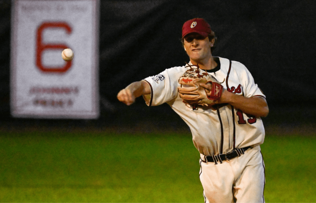 Mark Henson, wearing the 1952 Boston Braves #19 jersey of Joe Morgan, throws the ball to first base after field the ball during the Oldtime Baseball game at St. Peter's Field in Cambridge, Thursday, Aug. 24, 2023.