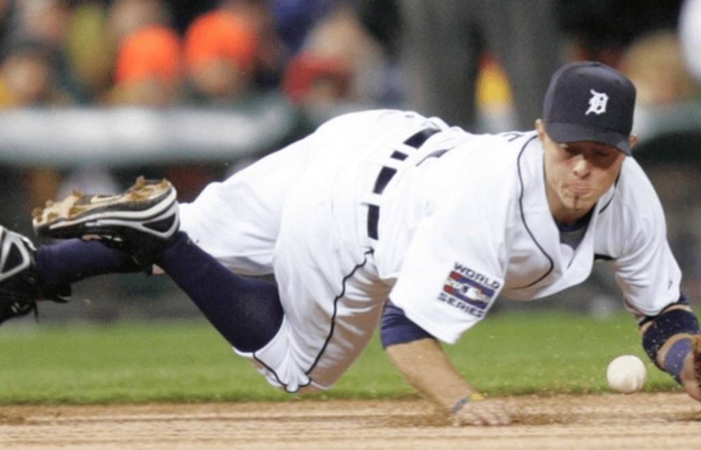 Detroit Tigers' Brandon Inge dives for the ball but cannot handle the ball hit by Scott Rolen in the first inning of Game 2 of the World Series against the St. Louis Cardinals at Comerica Park in Detroit, Sunday, Oct. 22, 2006