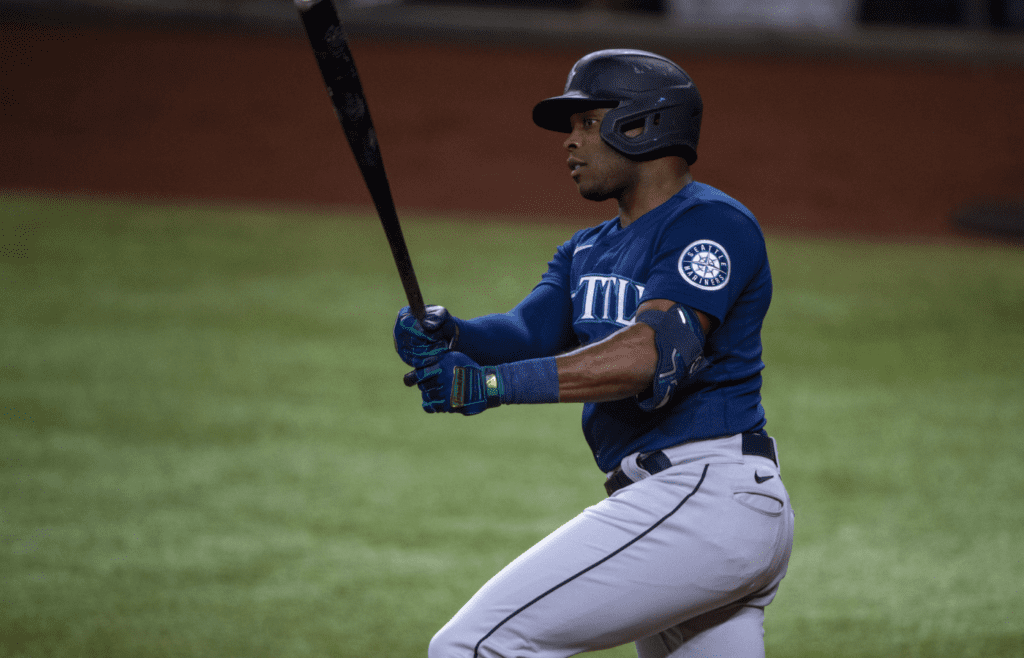 Jul 15, 2022; Arlington, Texas, USA; Seattle Mariners designated hitter Justin Upton (8) drives in a run against the Texas Rangers during the fourth inning at Globe Life Field. Mandatory Credit: Jerome Miron-Imagn Images
