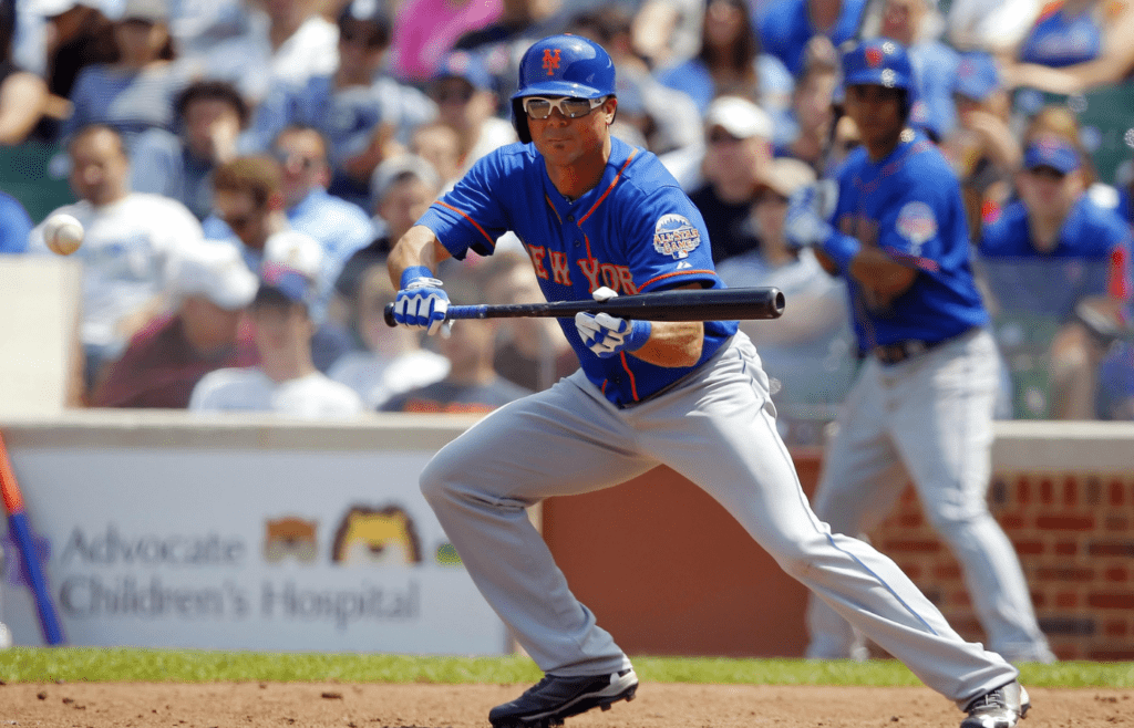 May 18, 2013; Chicago, IL, USA; New York Mets center fielder Rick Ankiel (16) bunts for a single during the seventh inning against the Chicago Cubs at Wrigley Field. Chicago won 8-2. Mandatory Credit: Dennis Wierzbicki-Imagn Images