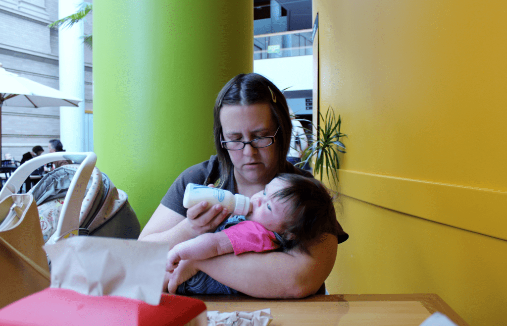 Giving a baby a bottle of milk