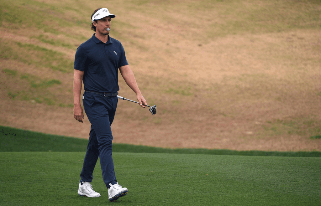 Jan 22, 2021; La Quinta, California, USA; Jamie Lovemark walks the first fairway as he blows a bubble gum bubble during the second round of The American Express golf tournament at PGA West Peter Dye Stadium Course. Mandatory Credit: Orlando Ramirez-Imagn Images