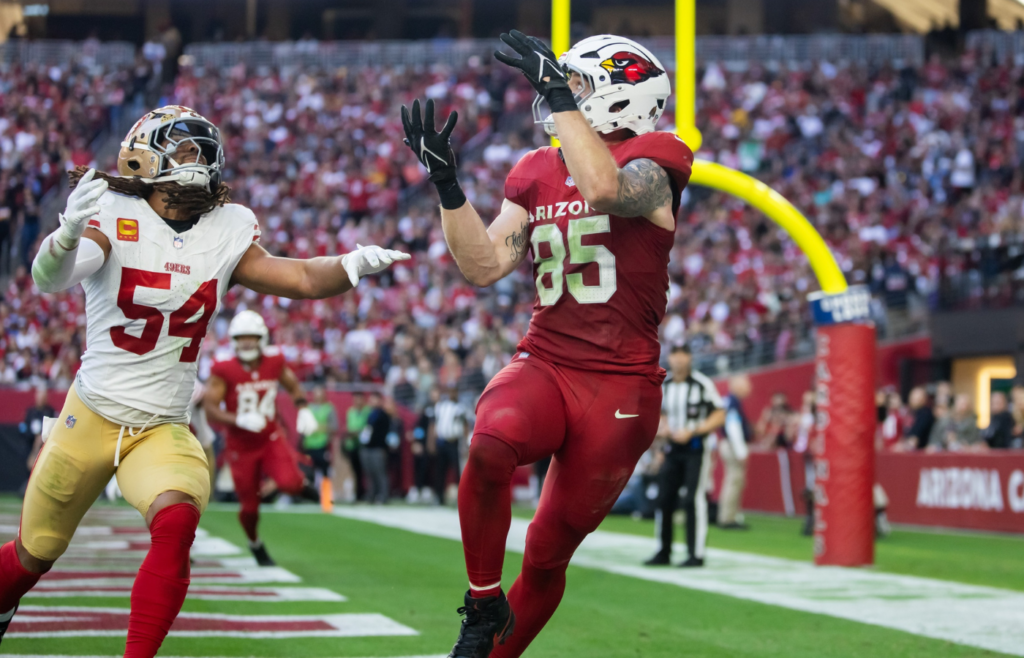 Jan 5, 2025; Glendale, Arizona, USA; Arizona Cardinals tight end Trey McBride (85) catches a touchdown pass against San Francisco 49ers linebacker Fred Warner (54) in the first half at State Farm Stadium. Mandatory Credit: Mark J. Rebilas-Imagn Images
