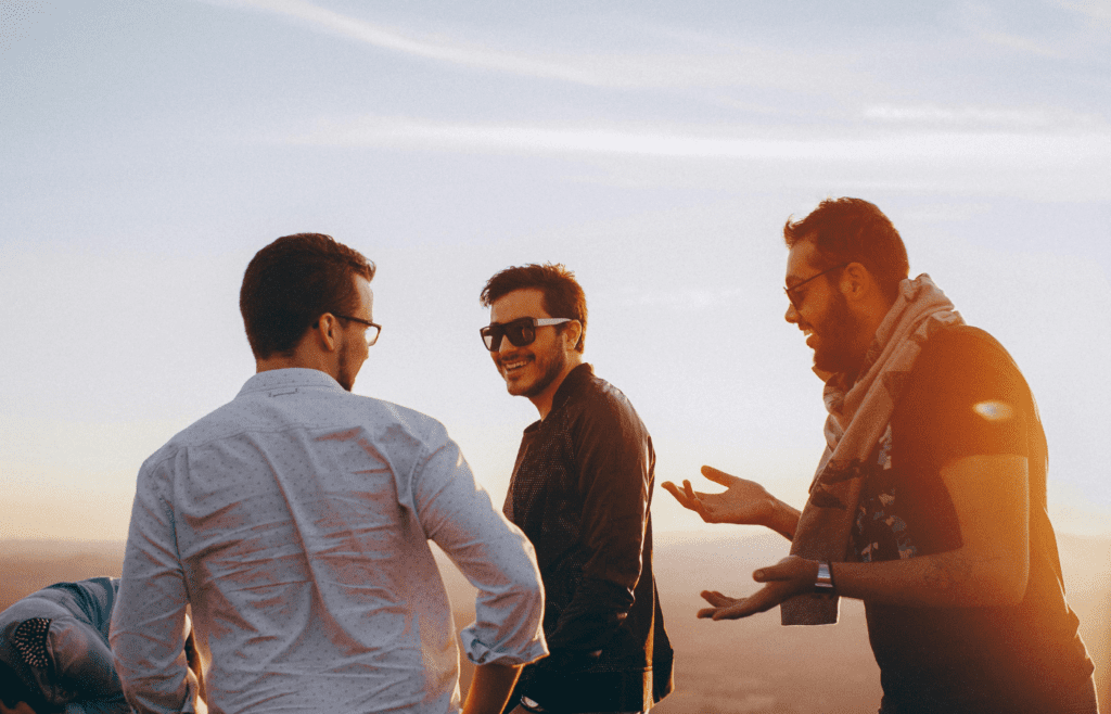 Group of friends smiling and chatting outdoors