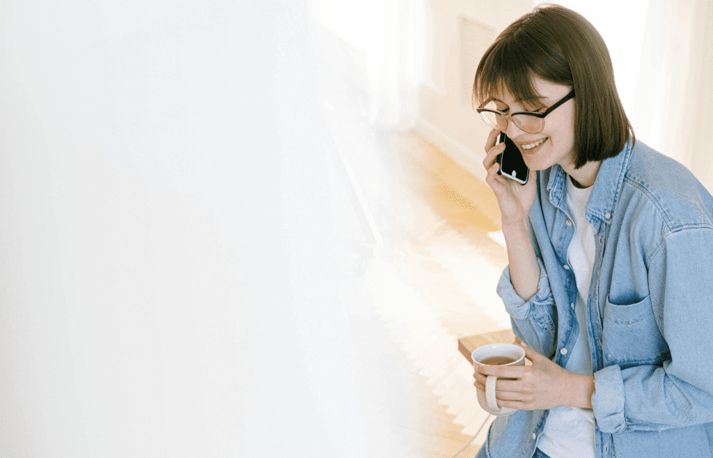 Woman smiling while talking on phone with friend