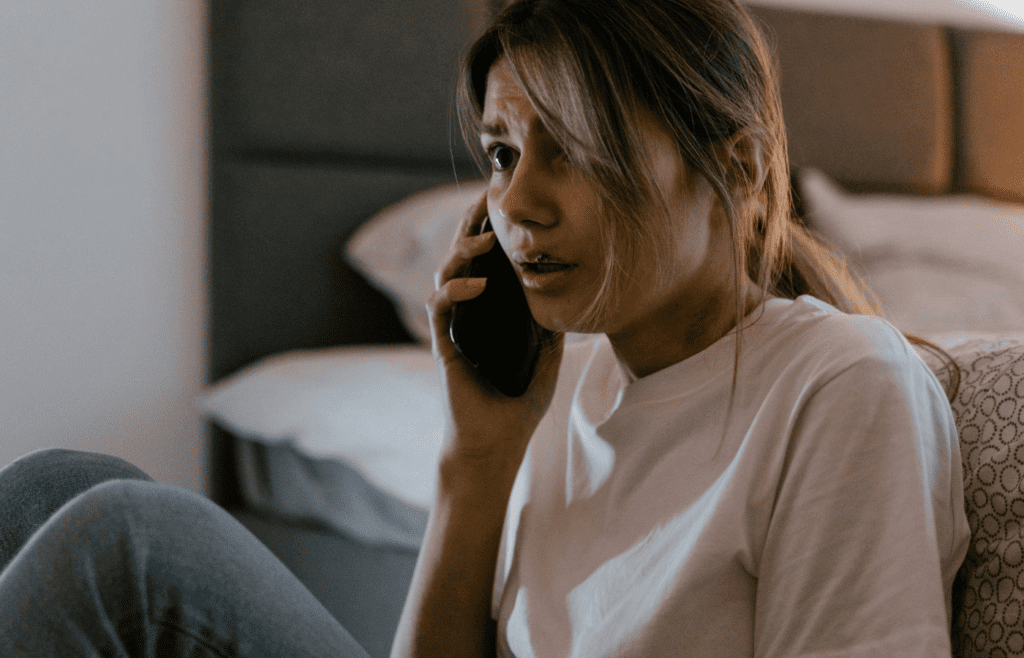 A Woman in White Shirt Calling on Her Cellphone