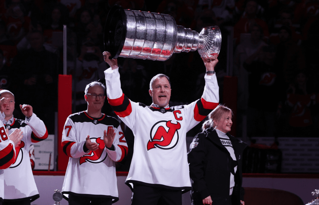 Feb 25, 2023; Newark, New Jersey, USA; New Jersey Devils defenseman Scott Stevens (4) holds up the Stanley Cup as the 2003 team is honored before the start of the game between the New Jersey Devils and the Philadelphia Flyers at Prudential Center. Mandatory Credit: Ed Mulholland-Imagn Images