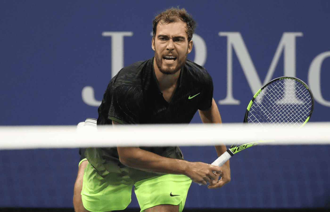 Aug 29, 2016; New York, NY, USA; Jerzy Janowicz of Poland serves against Novak Djokovic of Serbia on day one of the 2016 U.S. Open tennis tournament at USTA Billie Jean King National Tennis Center. Mandatory Credit: Geoff Burke-Imagn Images