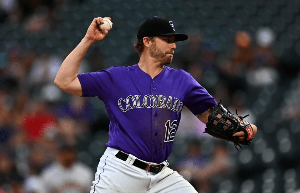 Jul 15, 2019; Denver, CO, USA; Colorado Rockies relief pitcher Mark Reynolds (12) delivers a pitch in the ninth inning against the San Francisco Giants at Coors Field. Mandatory Credit: Ron Chenoy-Imagn Images