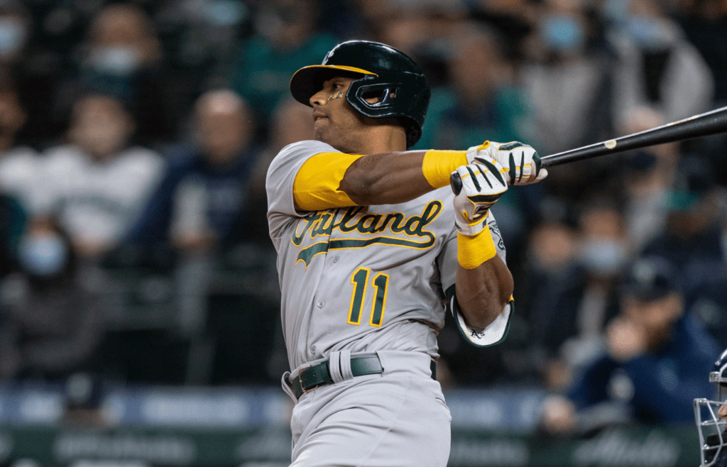 Sep 27, 2021; Seattle, Washington, USA; Oakland Athletics designated hitter Khris Davis (11) takes a swing during an at-bat in a game against the Seattle Mariners at T-Mobile Park. The Mariners won 13-4. Mandatory Credit: Stephen Brashear-Imagn Images