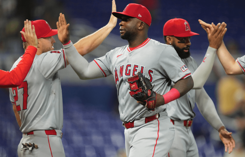Apr 3, 2024; Miami, Florida, USA; Los Angeles Angels first baseman Miguel Sano (22) celebrates a victory against the Miami Marlins at loanDepot Park. Mandatory Credit: Jim Rassol-Imagn Images