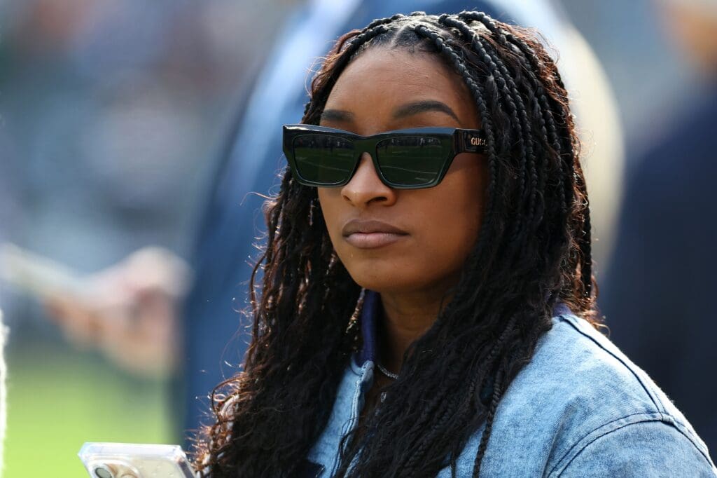 Nov 24, 2024; Chicago, Illinois, USA; United States gymnast Simone Biles watches practice before the game against between the Minnesota Vikings and Chicago Bears at Soldier Field. Mandatory Credit: Mike Dinovo-Imagn Images