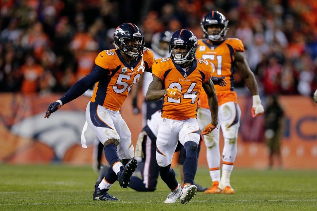 Nov 4, 2018; Denver, CO, USA; Denver Broncos cornerback Adam Jones (24) celebrates with outside linebacker Von Miller (58) after a play in the fourth quarter against the Houston Texans at Broncos Stadium at Mile High. Mandatory Credit: Isaiah J. Downing-USA TODAY Sports