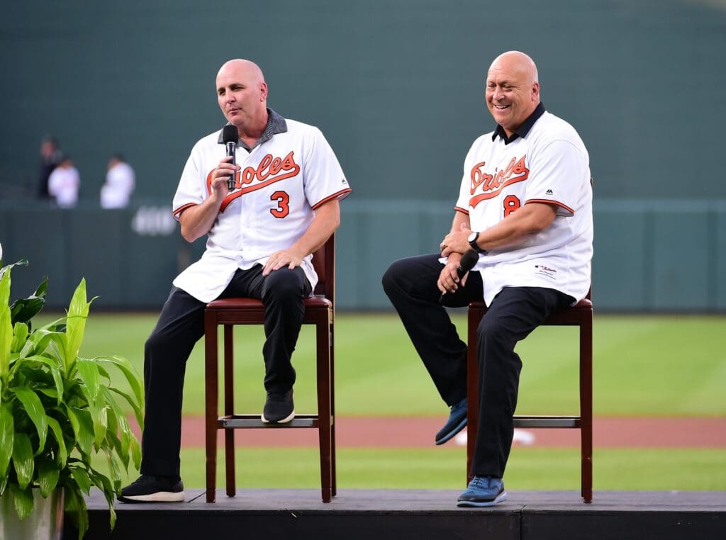 Aug 9, 2019; Baltimore, MD, USA; Former Baltimore Orioles players Billy Ripken (3) and Cal Ripken Jr. (8) talk to the fans prior to the game against the Houston Astros at Oriole Park at Camden Yards. Mandatory Credit: Evan Habeeb-USA TODAY Sports