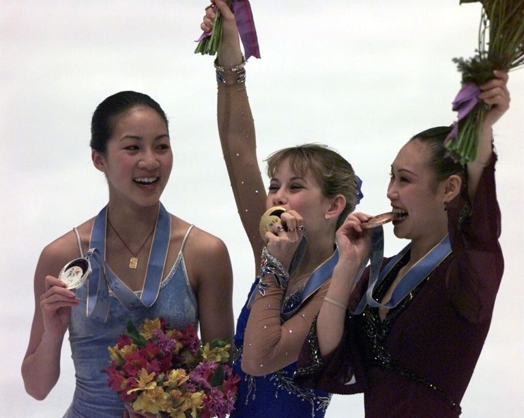 DATE TAKEN: 2/20/98---USA's Michelle Kwan, left, and Tara Lipinski and Lu Chen (China) wave to the crowd after being awarded the silver, gold and bronze medals, respectivelyl, in the Ladies Figure Skating final. Mandatory Credit: Alan Lessig/USA Today