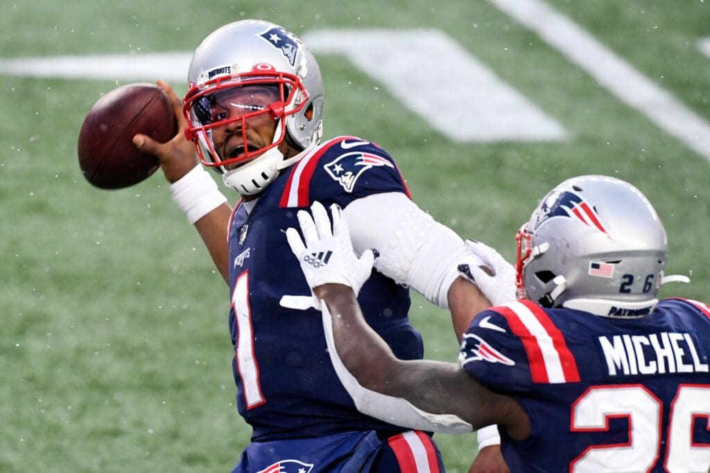 Jan 3, 2021; Foxborough, Massachusetts, USA; New England Patriots quarterback Cam Newton (1) celebrates with running back Sony Michel (26) after scoring a touchdown against the New York Jets during the forth quarter at Gillette Stadium. Mandatory Credit: Brian Fluharty-USA TODAY Sports