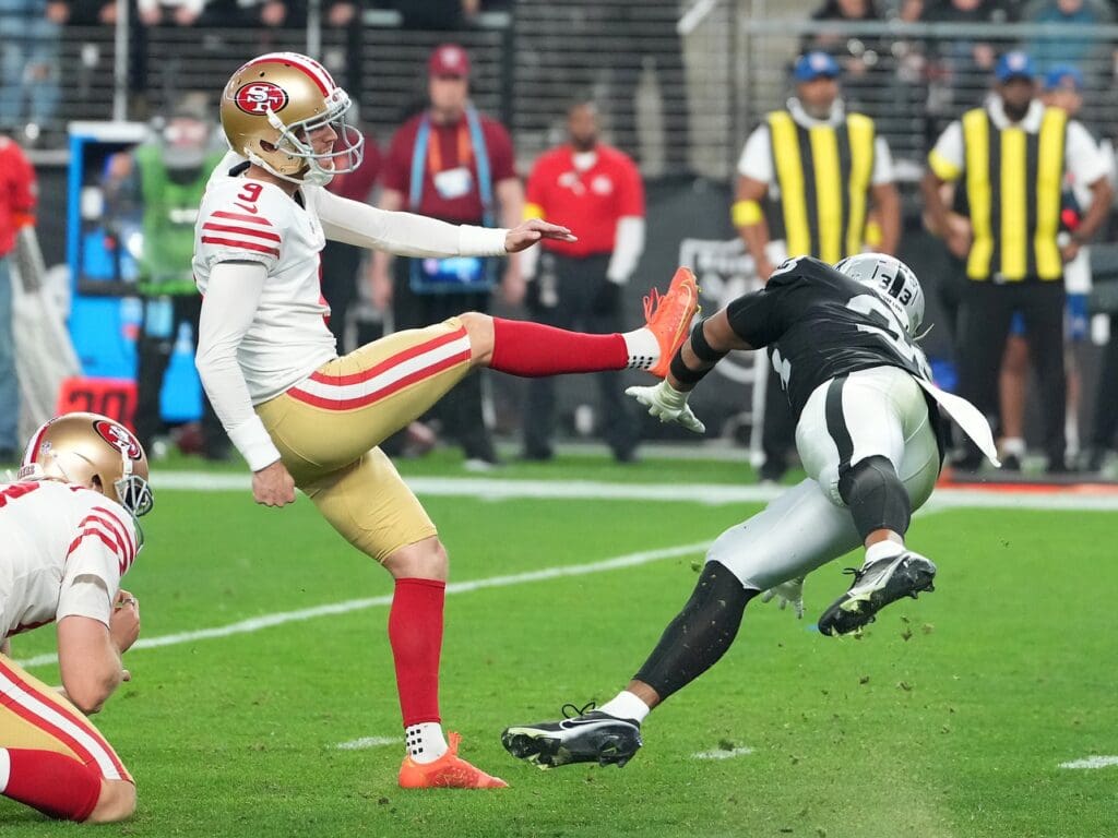 Jan 1, 2023; Paradise, Nevada, USA; San Francisco 49ers place kicker Robbie Gould (9) kicks a field goal as Las Vegas Raiders safety Roderic Teamer (33) attempts a block during an overtime period at Allegiant Stadium. Mandatory Credit: Stephen R. Sylvanie-USA TODAY Sports