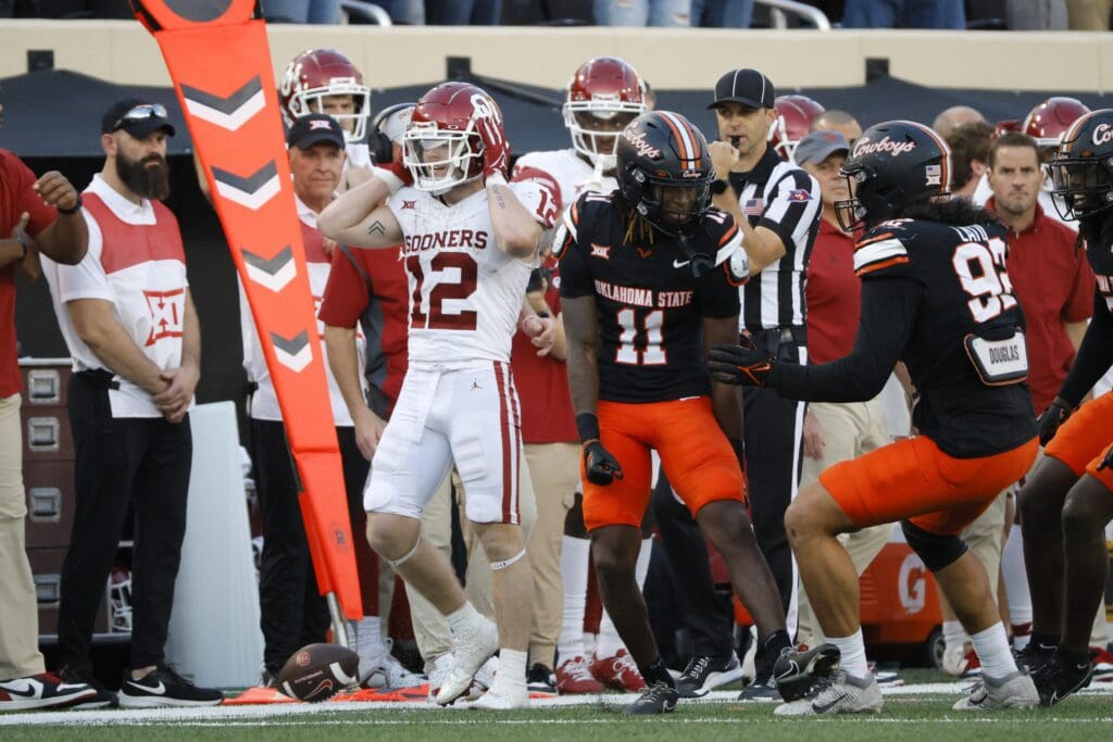 Nov 4, 2023; Stillwater, Oklahoma, USA; Oklahoma State Cowboys cornerback Dylan Smith (11) and defensive end Nathan Latu (92) celebrate next to Oklahoma Sooners wide receiver Drake Stoops (12) after a fourth down stop late in the fourth quarter of a Bedlam college football game between the Oklahoma State University Cowboys (OSU) and the University of Oklahoma Sooners (OU) at Boone Pickens Stadium. Mandatory Credit: Bryan Terry-USA TODAY Sports