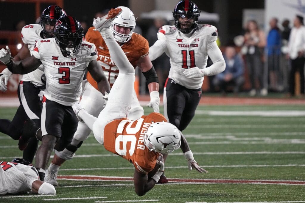 Nov 24, 2023; Austin, Texas, USA; Texas Longhorns running back Quintrevion Wisner (26) leaps while running for yards during the second half against the Texas Tech Red Raiders at Darrell K Royal-Texas Memorial Stadium. Mandatory Credit: Scott Wachter-USA TODAY Sports