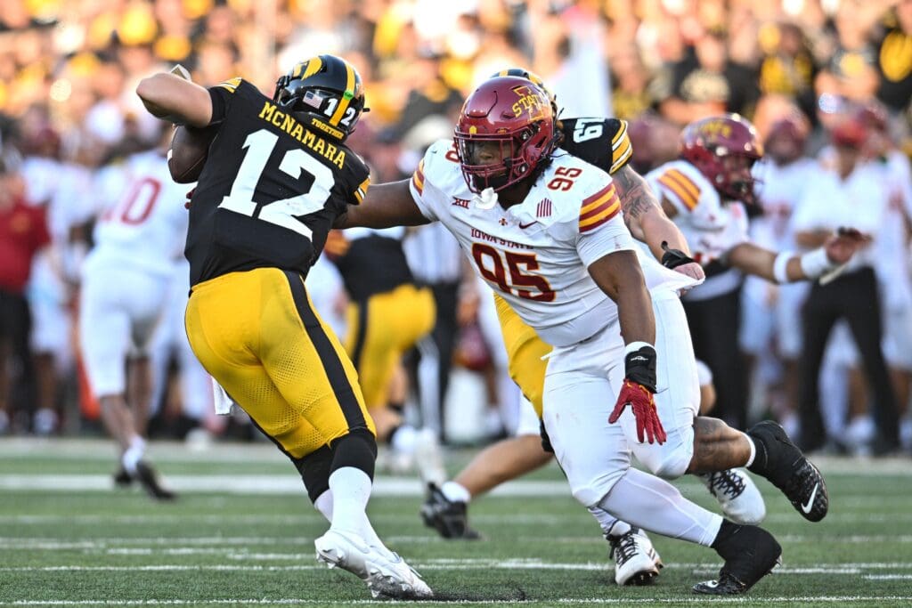 Sep 7, 2024; Iowa City, Iowa, USA; Iowa State Cyclones defensive lineman Domonique Orange (95) sacks Iowa Hawkeyes quarterback Cade McNamara (12) during the fourth quarter at Kinnick Stadium. Mandatory Credit: Jeffrey Becker-Imagn Images