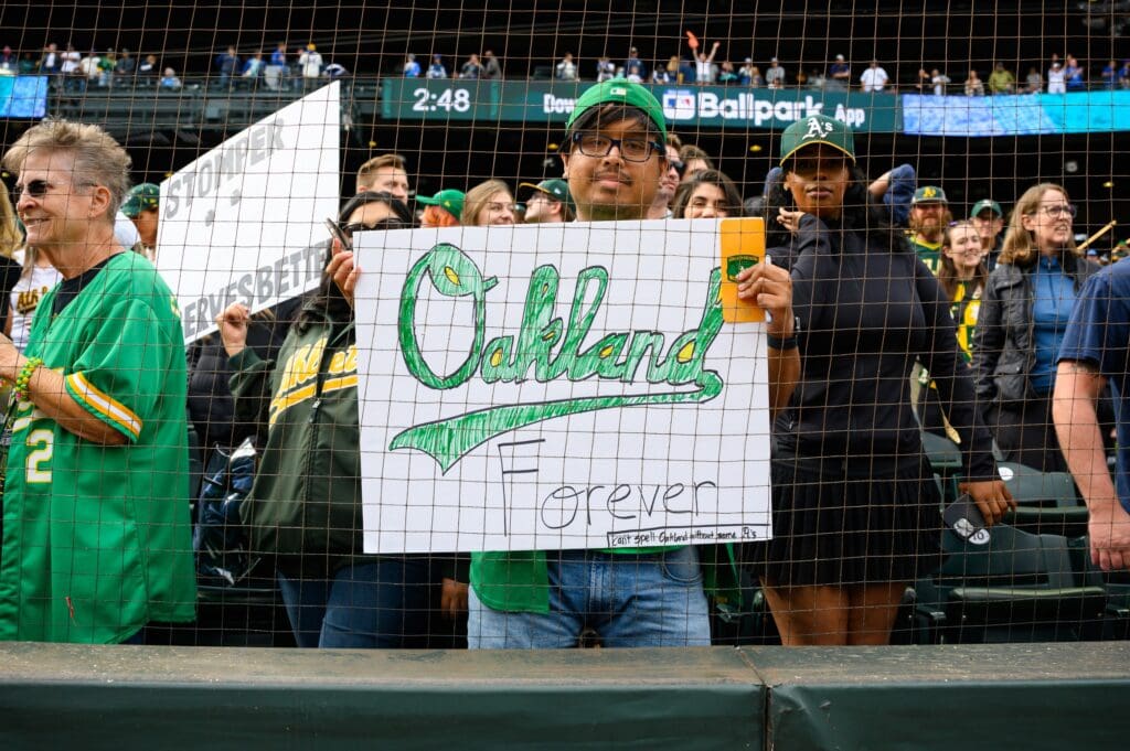 Sep 29, 2024; Seattle, Washington, USA; An Oakland Athletics fan holds a sign after the game between the Seattle Mariners and the Oakland Athletics at T-Mobile Park. Mandatory Credit: Steven Bisig-Imagn Images