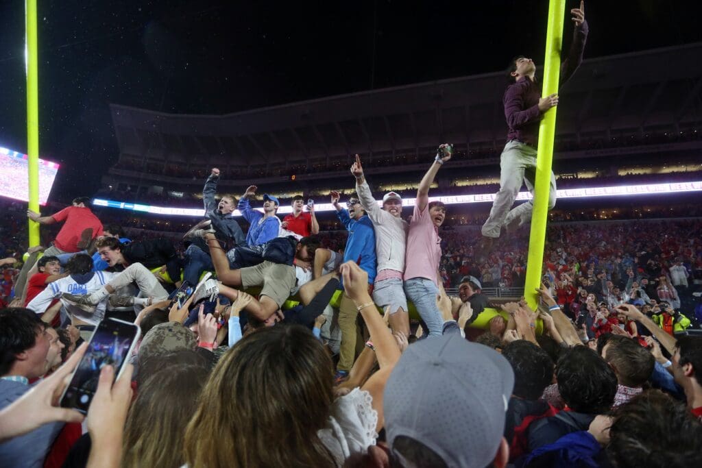 Nov 9, 2024; Oxford, Mississippi, USA; Mississippi Rebels fans attempt to tear down the goal post after defeating the Georgia Bulldogs at Vaught-Hemingway Stadium.