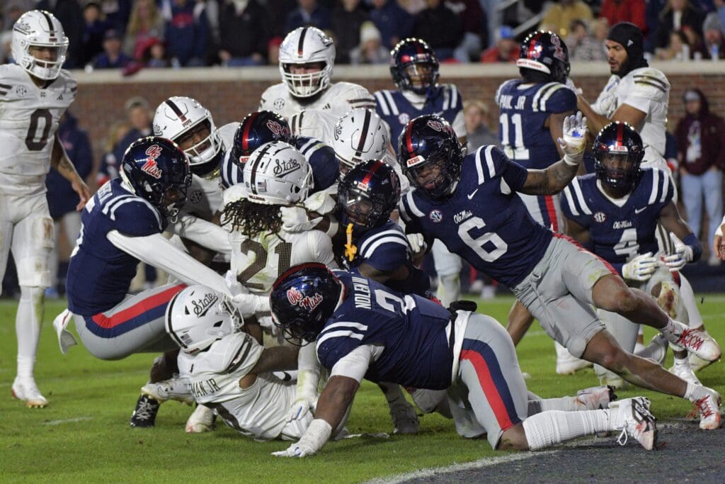 Nov 29, 2024; Oxford, Mississippi, USA; Mississippi State Bulldogs running back Davon Booth (21) is stopped short of the endzone by the Mississippi Rebels defense during the fourth quarter at Vaught-Hemingway Stadium. Mandatory Credit: Matt Bush-Imagn Images