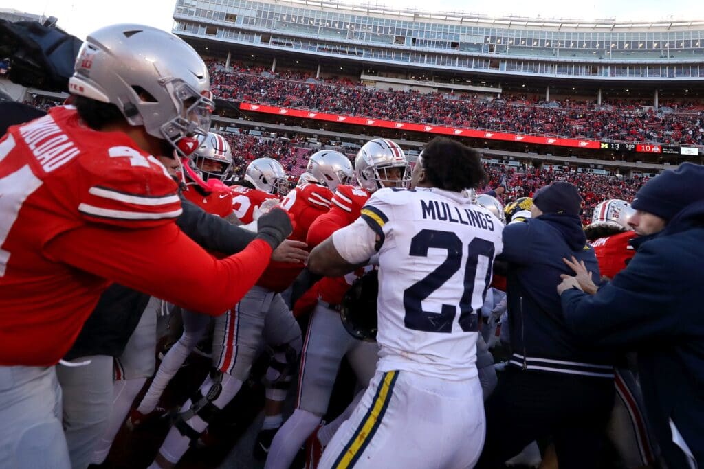 Nov 30, 2024; Columbus, Ohio, USA; Police attempt to break up Ohio State Buckeyes players and Michigan Wolverines players as they fight after the game at Ohio Stadium. Mandatory Credit: Joseph Maiorana-Imagn Images