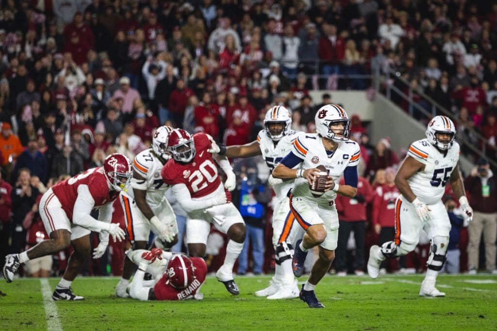 Nov 30, 2024; Tuscaloosa, Alabama, USA; Auburn Tigers quarterback Payton Thorne (1) runs the ball against the Alabama Crimson Tide during the fourth quarter at Bryant-Denny Stadium. Mandatory Credit: Will McLelland-Imagn Images
