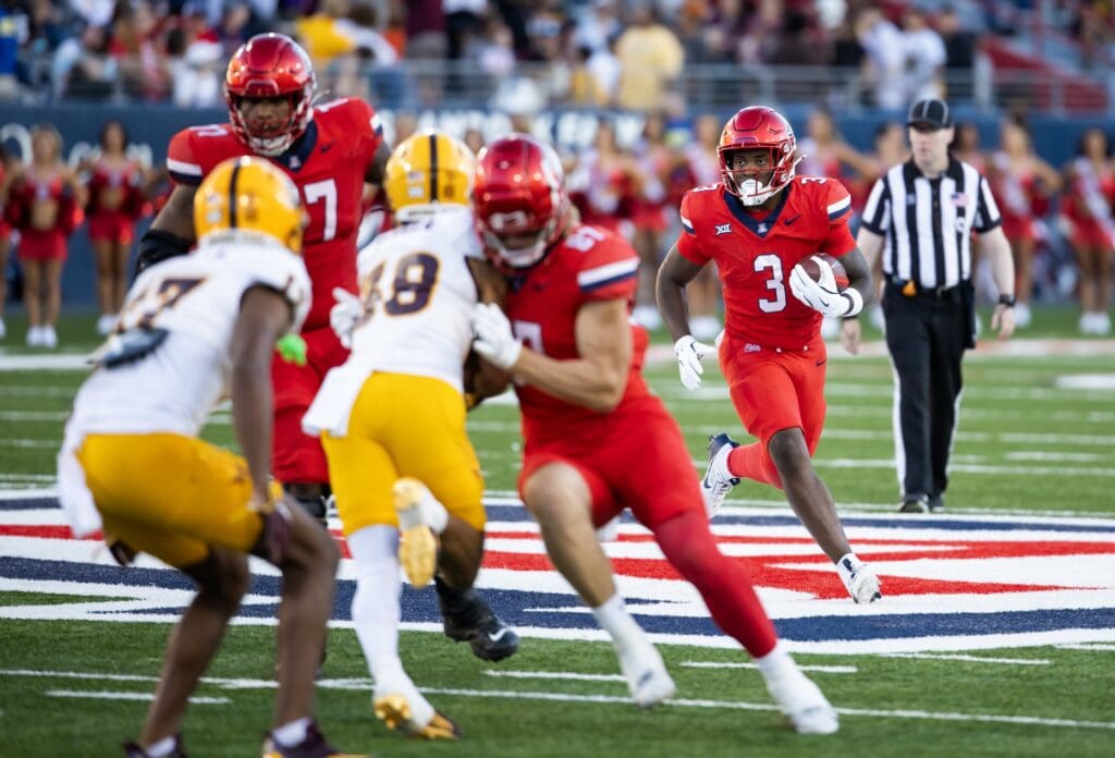 Nov 30, 2024; Tucson, Arizona, USA; Arizona Wildcats running back Kedrick Reescano (3) against the Arizona State Sun Devils during the Territorial Cup at Arizona Stadium. Mandatory Credit: Mark J. Rebilas-Imagn Images
