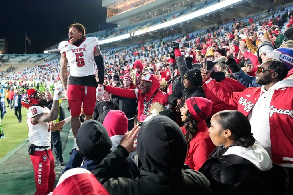 Nov 30, 2024; Chapel Hill, North Carolina, USA; North Carolina State Wolfpack safety DK Kaufman (5) and wide receiver Kevin Concepcion (10) react with fans after the game at Kenan Memorial Stadium.