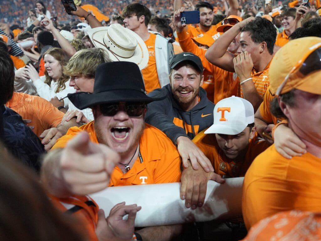 Tennessee fans carry a goalpost across the field after it was taken down after Tennessee's win over Alabama in an NCAA college football game on Saturday, Oct. 19, 2024, in Knoxville. Tenn.