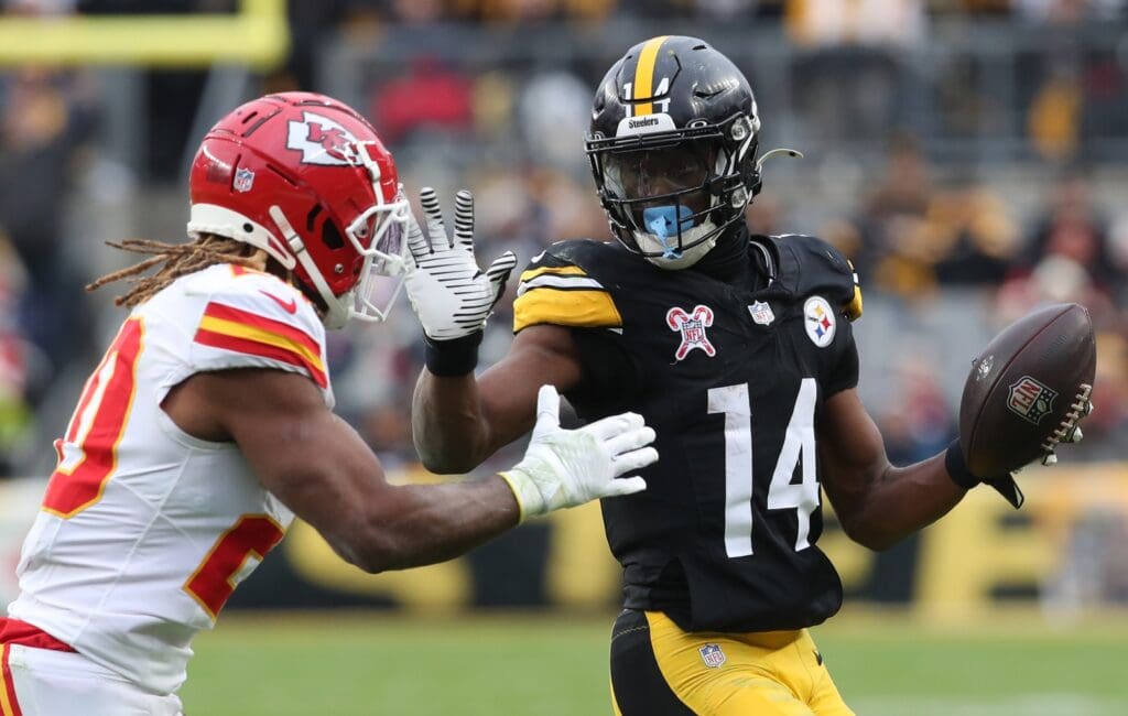Dec 25, 2024; Pittsburgh, Pennsylvania, USA; Pittsburgh Steelers wide receiver George Pickens (14) runs after a catch as Kansas City Chiefs safety Justin Reid (20) defends during the fourth quarter at Acrisure Stadium. Mandatory Credit: Charles LeClaire-Imagn Images
