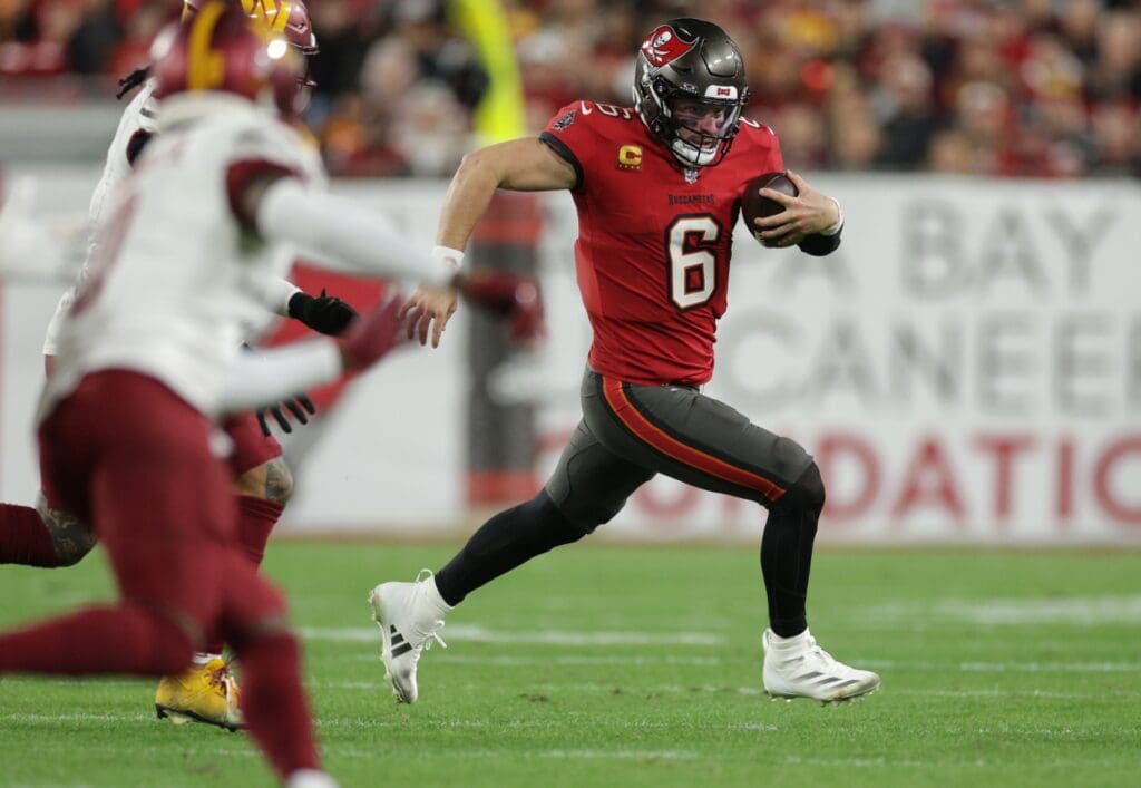 Jan 12, 2025; Tampa, Florida, USA; Tampa Bay Buccaneers quarterback Baker Mayfield (6) scrambles during the fourth quarter of a NFC wild card playoff against the Washington Commanders at Raymond James Stadium. Mandatory Credit: Nathan Ray Seebeck-Imagn Images