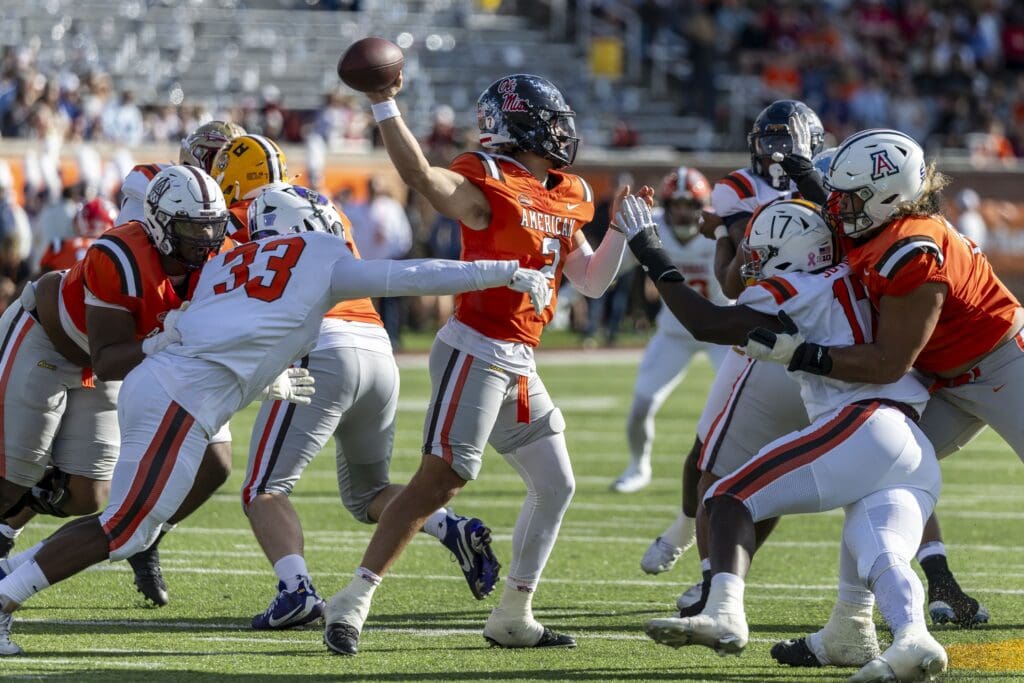 Feb 1, 2025; Mobile, AL, USA; National team defensive lineman David Walker of Central Arkansas (33) and National team defensive lineman Jah Joyner of Minnesota (17) pressures American team quarterback Jaxson Dart of Ole Miss (2) during the first half of the 2025 Senior Bowl football game at Hancock Whitney Stadium. Mandatory Credit: Vasha Hunt-Imagn Images
