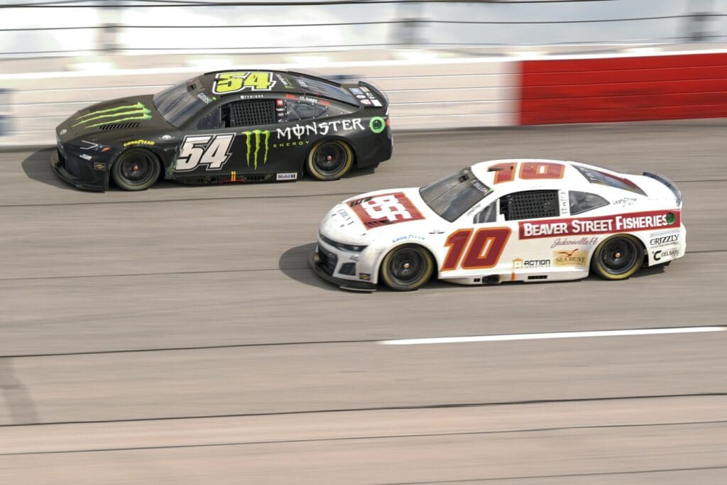 Apr 6, 2025; Darlington, South Carolina, USA; NASCAR Cup Series driver Ty Gibbs (54) and driver Ty Dillon (10) during the Goodyear 400 at Darlington Raceway. Mandatory Credit: Jim Dedmon-Imagn Images