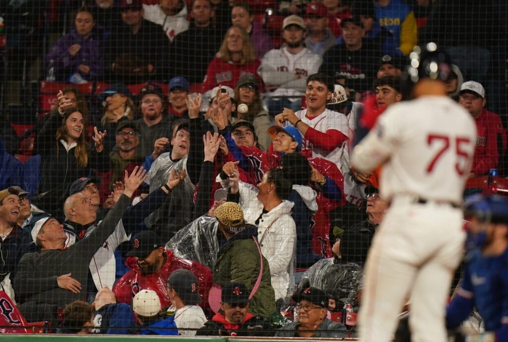 May 6, 2025; Boston, Massachusetts, USA; Fans work for the ball as the Boston Red Sox take on the Texas Rangers in the fifth inning at Fenway Park. Mandatory Credit: David Butler II-Imagn Images