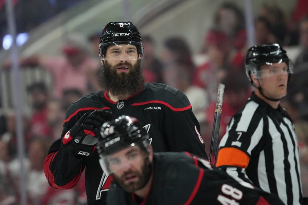 May 20, 2025; Raleigh, North Carolina, USA; Carolina Hurricanes defenseman Brent Burns (8) and forward Jordan Martinook (48) look on during the third period against the Florida Panthers in game one of the Eastern Conference Final of the 2025 Stanley Cup Playoffs at Lenovo Center. Mandatory Credit: James Guillory-Imagn Images