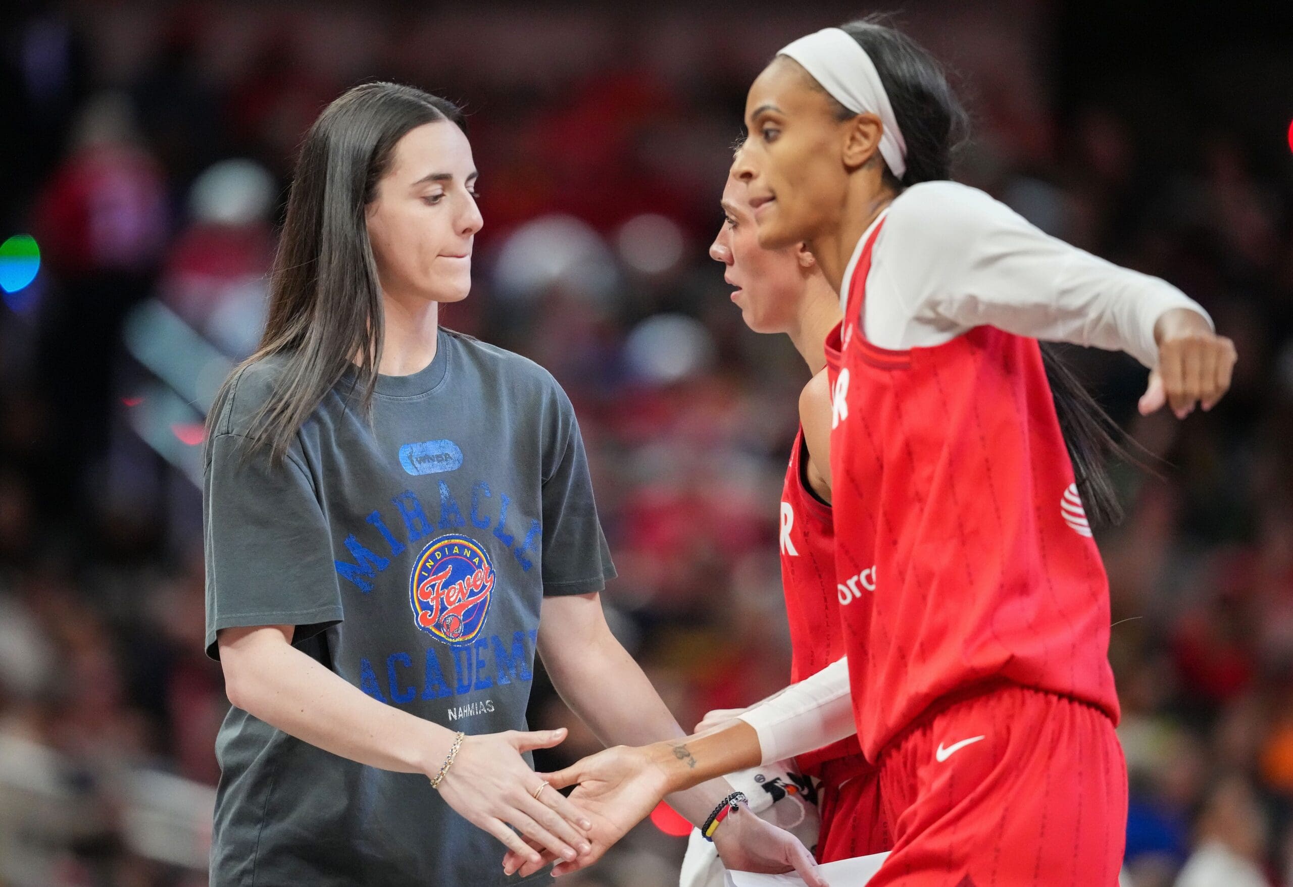 Indiana Fever guard Caitlin Clark (22) high-flves Indiana Fever forward DeWanna Bonner (25) on Friday, May 30, 2025, during the game at Gainbridge Fieldhouse in Indianapolis. The Connecticut Sun defeated the Indiana Fever, 85-83.