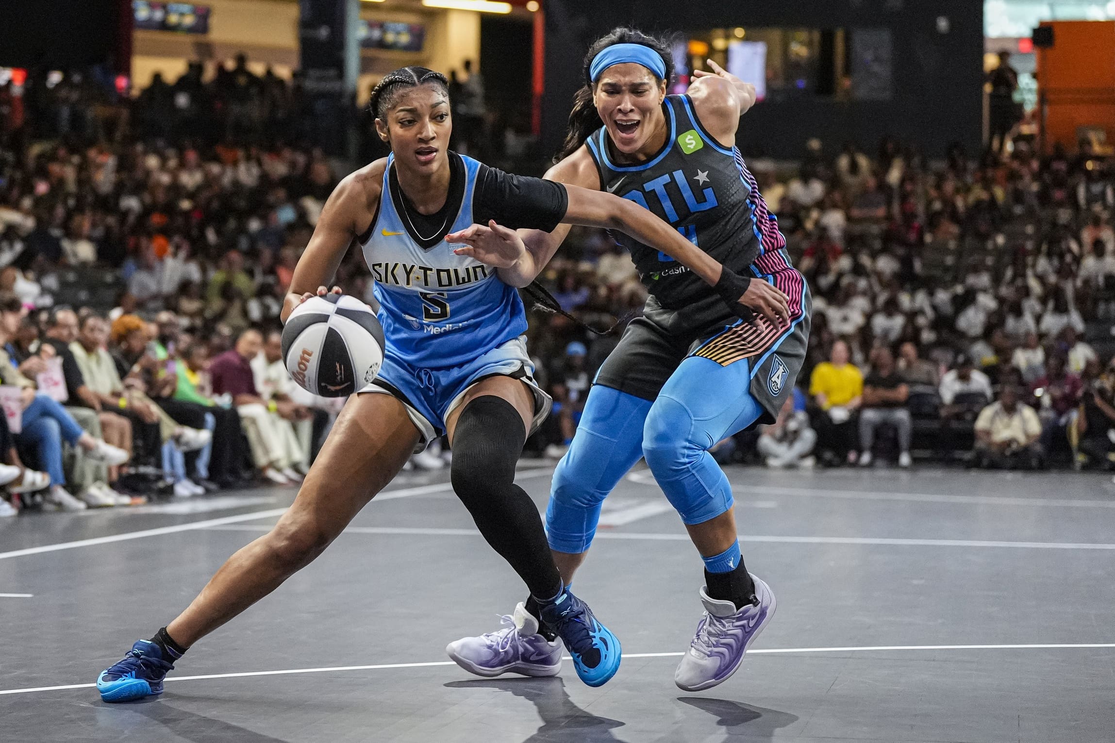 Jun 13, 2025; College Park, Georgia, USA; Chicago Sky forward Angel Reese (5) dribbles against Atlanta Dream forward Brionna Jones (24) during the first half at Gateway Center Arena at College Park. Mandatory Credit: Dale Zanine-Imagn Images
