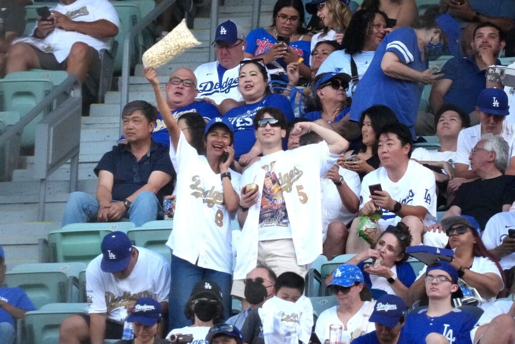 Jun 18, 2025; Los Angeles, California, USA; Los Angeles Dodgers fans Grace Padilla (left) and son Christopher Torres pose during the game against the San Diego Padres at Dodger Stadium. Mandatory Credit: Kirby Lee-Imagn Images