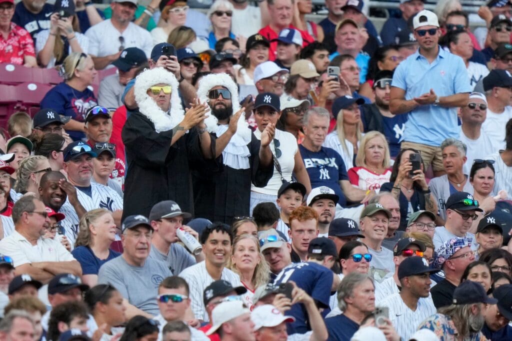 Fan of New York Yankees outfielder Aaron Judge (99) stand as he comes to bat in the first inning of the MLB interleague game between the Cincinnati Reds and the New York Yankees at Great American Ball Park in downtown Cincinnati on Monday, June 23, 2025.